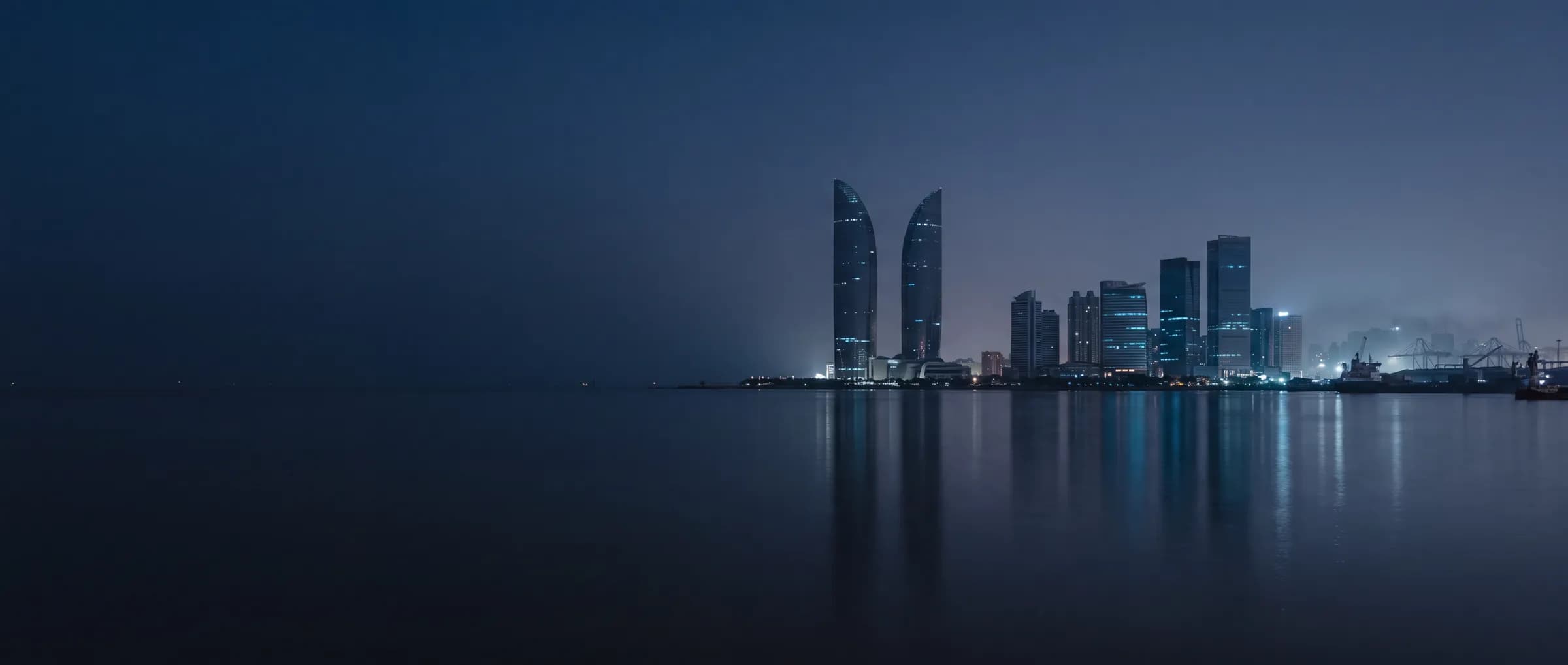 Xiamen waterfront skyline illuminated in blue at night