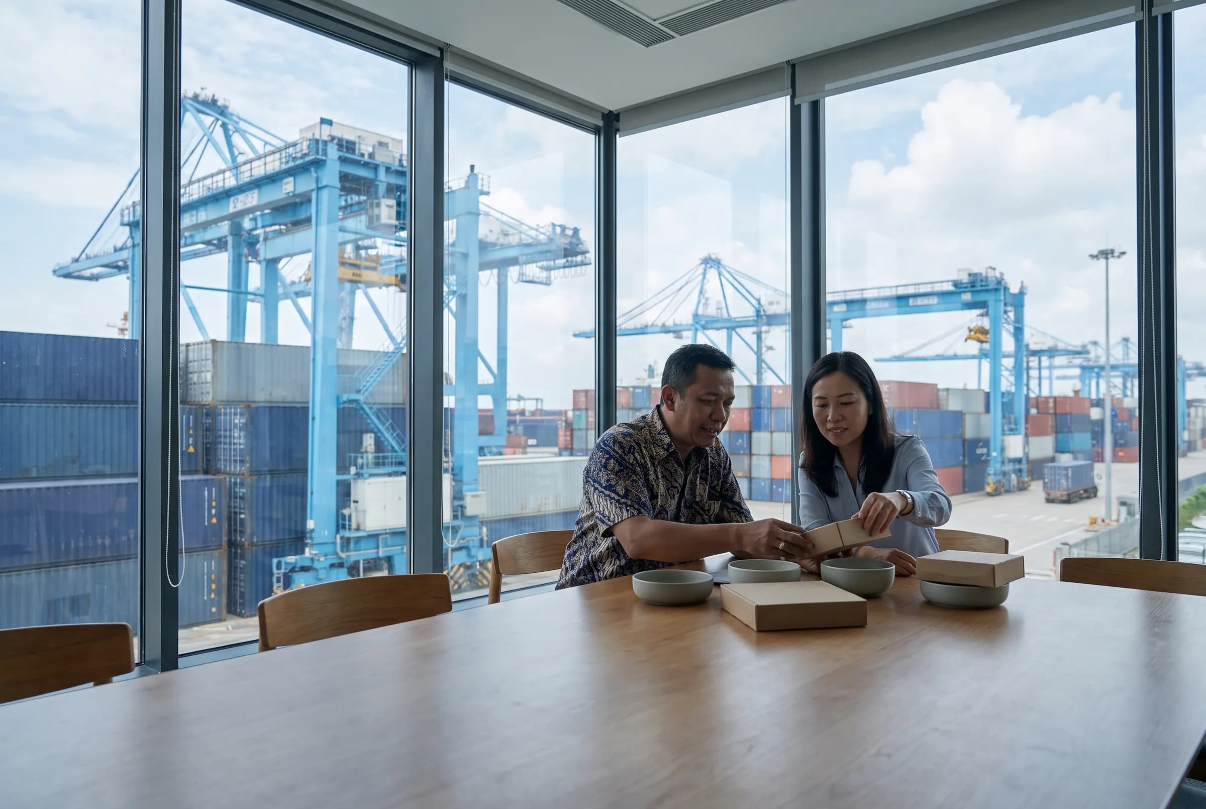 Trade specialists reviewing material samples beside Xiamen harbour